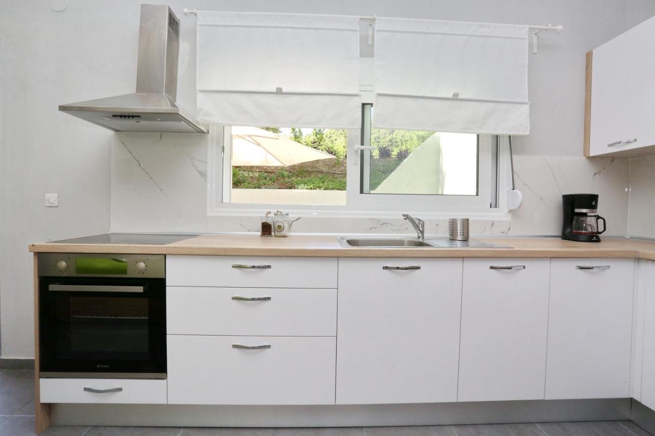 Close-up of the kitchen counter, oven, sink, and bright window view