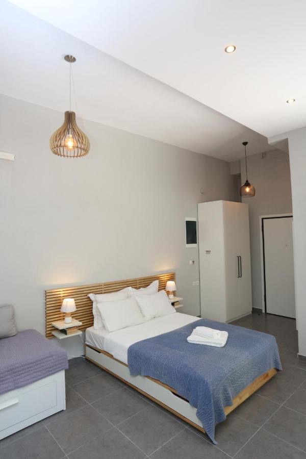Illuminated bedroom with pendant lights, wardrobe, and doorway