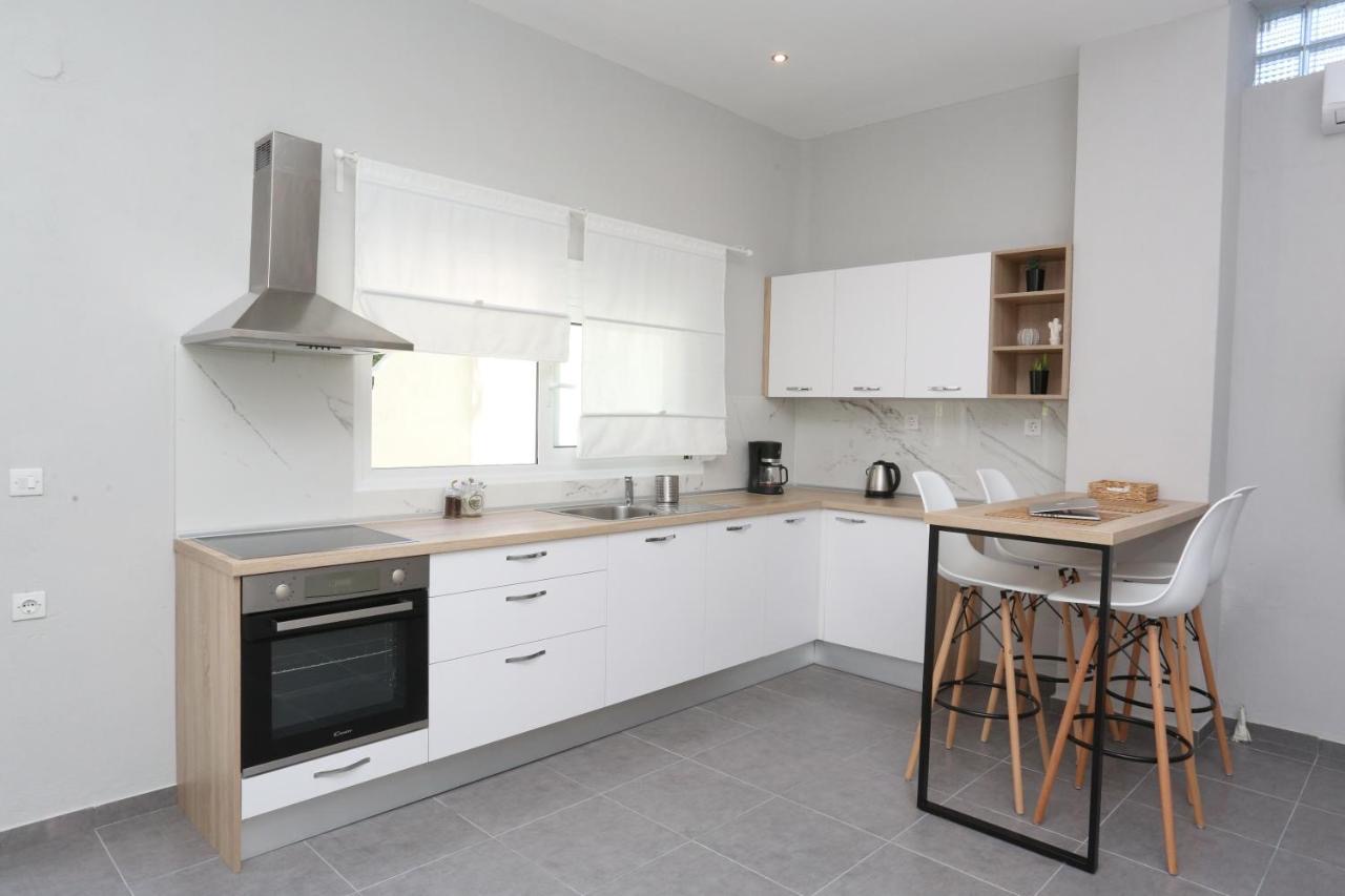 Modern, fully equipped kitchen with light wood accents and dining space