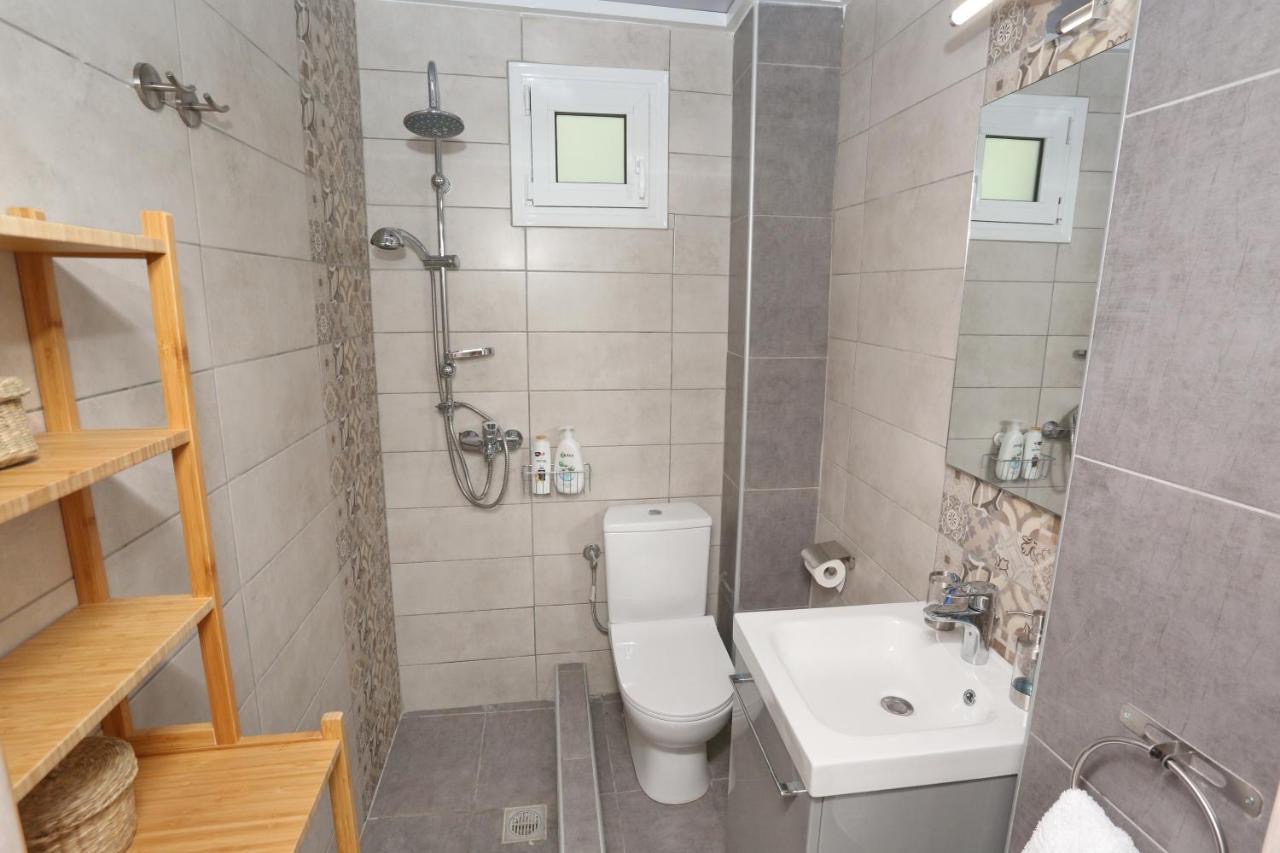 Modern bathroom with a walk-in shower, sink vanity, mirror and light-wood shelving